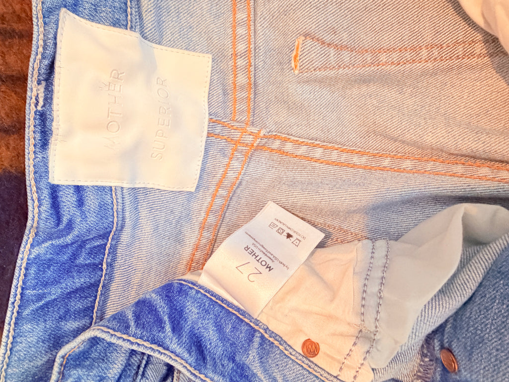 MOTHER Distressed Light Wash Boyfriend Jeans — care label